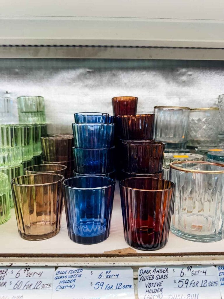 Clear glasses with gold rims and glasses of all different colors and style line the shelves at Jamali Floral and Garden.