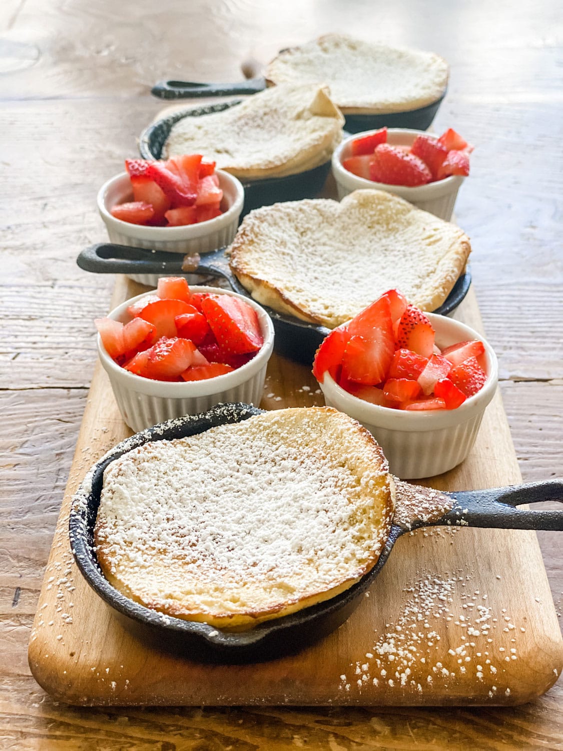 dutch baby pancakes, strawberries in small ramekin