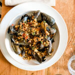mussels in bowl on wood table