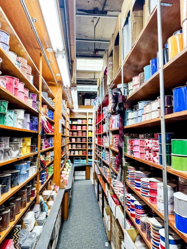 Rows and rows of ribbon for wrapping flowers line the shelves down an entire wall in this store.