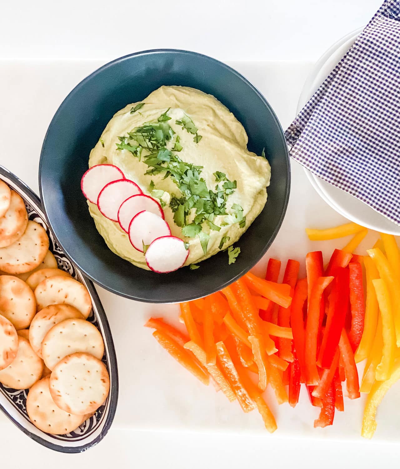 edamame hummus with tai color pepper and crackers in dish