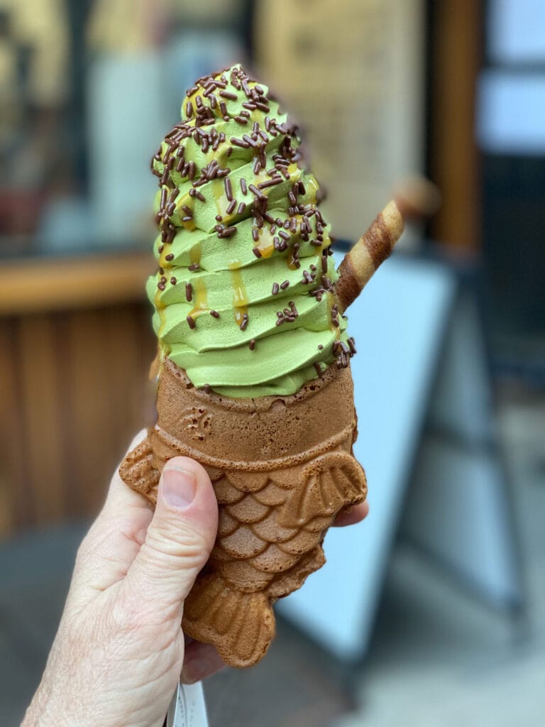 A green matcha ice cream in a fish-shaped cone at Taiyaki in Chinatown, New York.