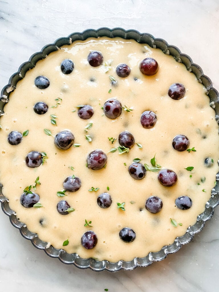 This Thomcord Grape Harvest Cake is slightly sweet, but earthy from the olive oil and fresh thyme too! Perfect for after dinner, lunch or serve for breakfast. It can be made ahead!