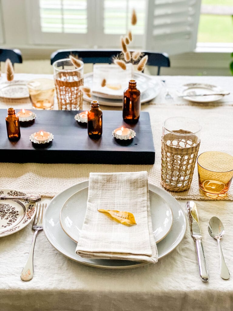 A Modern & Collected Thanksgiving Table using a little of what I had, some new napkins and some foraged finds in repurposed amber bottles with unscented candles