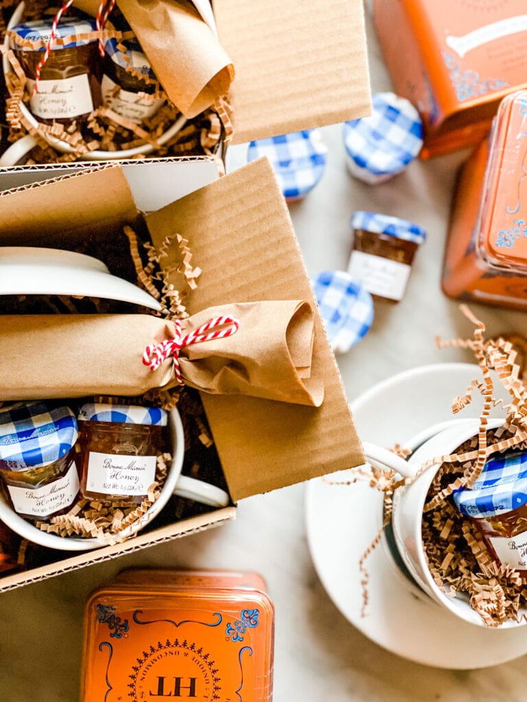 Gift boxes with cinnamon tea, honey, and a cup.