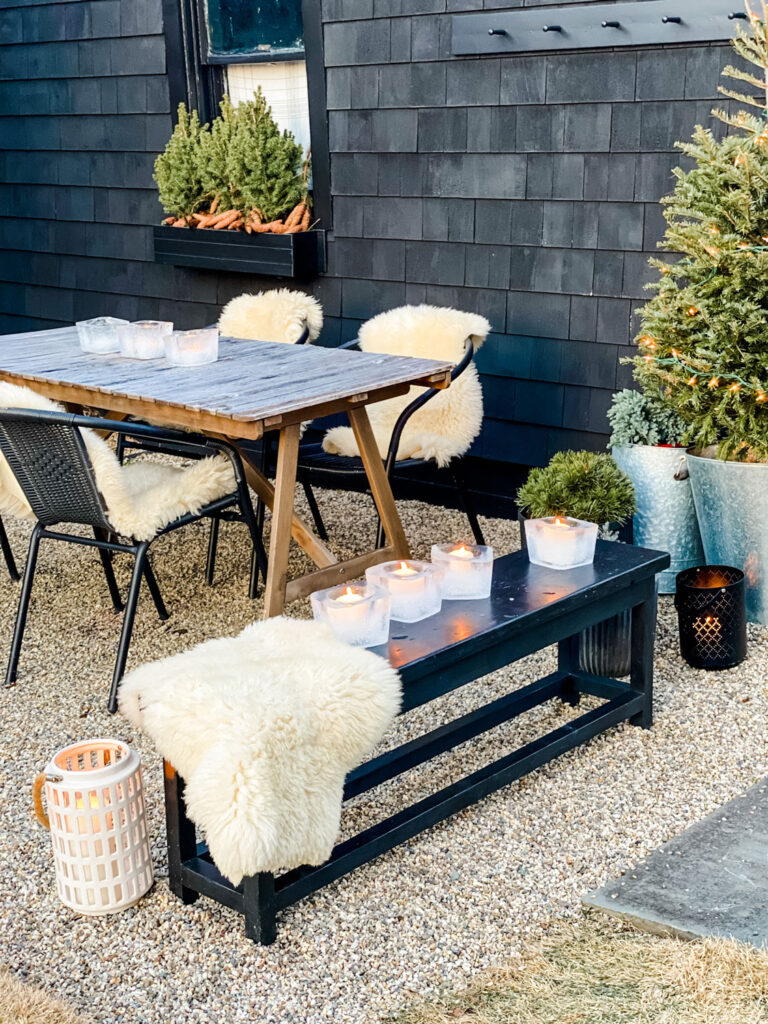 ice lanterns, bench, pea gravel patio, black building, ice lanterns