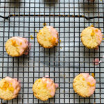 small cookies with pink glaze on cooling rack