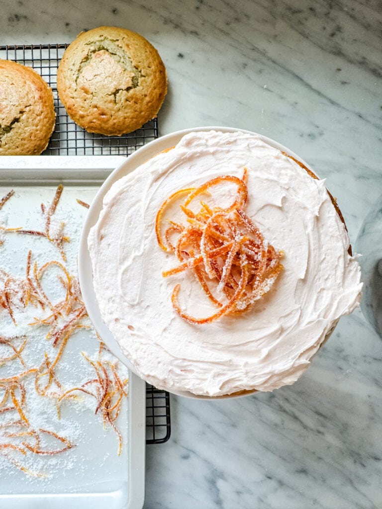 Candied orange peels are topping on blood orange olive oil cake and butter cream frosting.