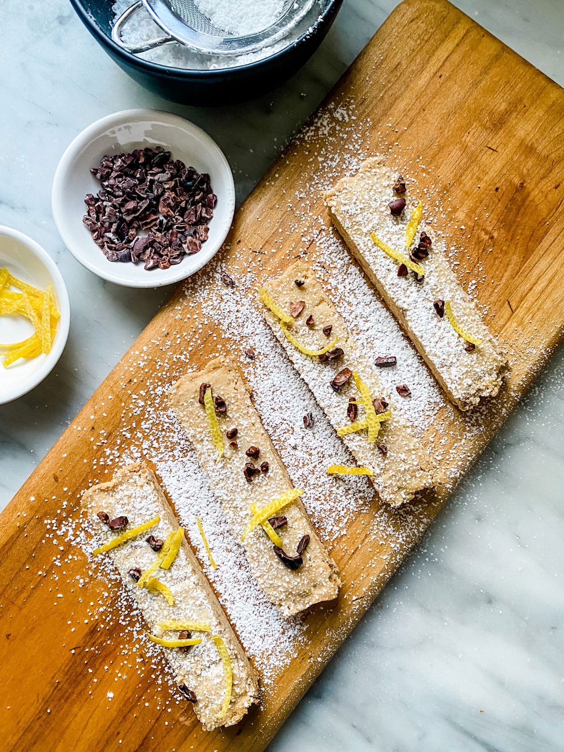 Shortbread bars on wood board With chocolate and lemon