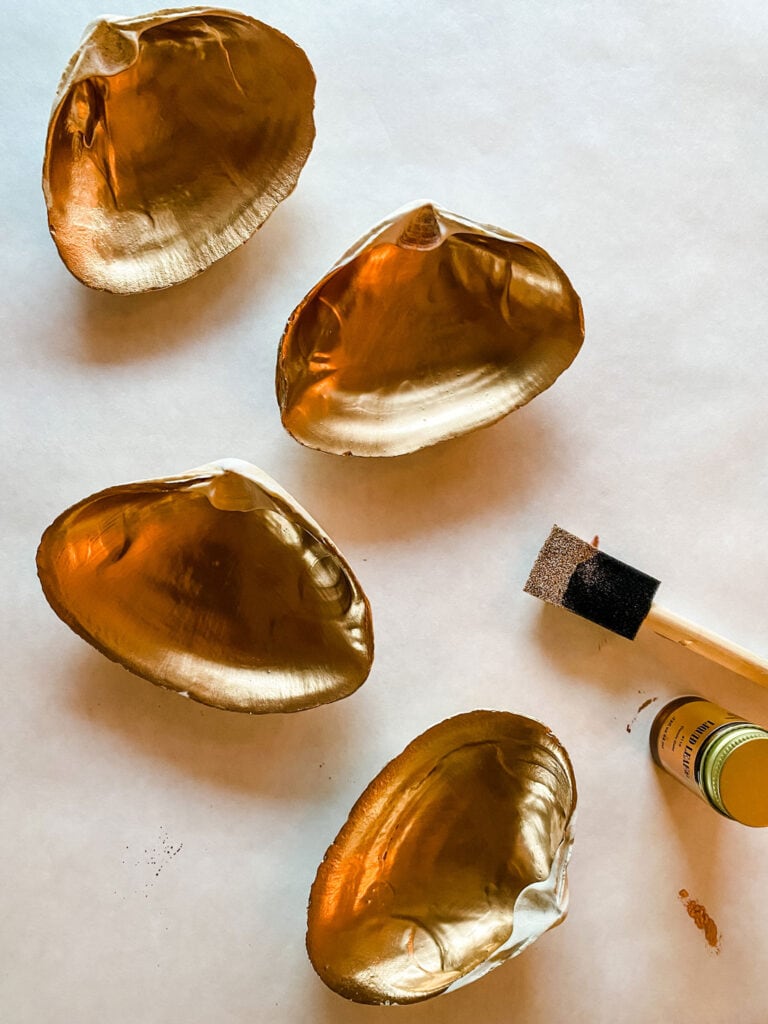 Making gold leaf clam shell salt cellars is a quick DIY project that looks perfect on any dining table.