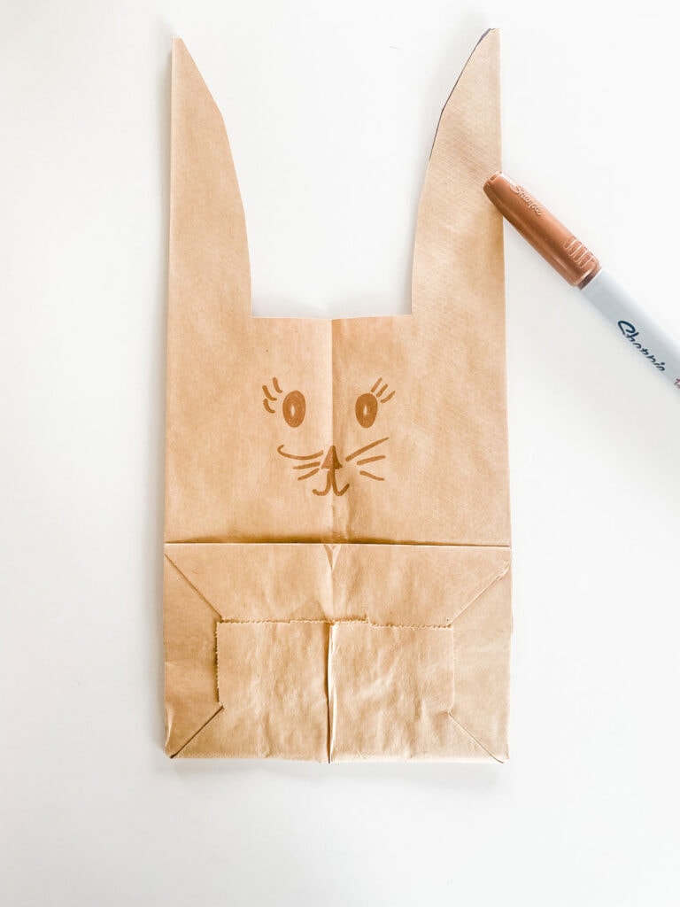 A brown lunch has been cut to form ears and a bunny face has been drawn on the bag with a marker.