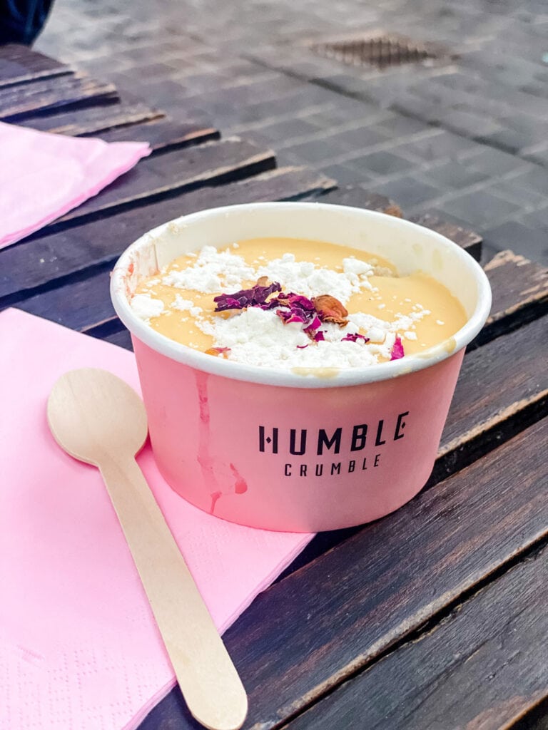 Humble Crumble served in pink cups with wooden spoons and pink napkins.