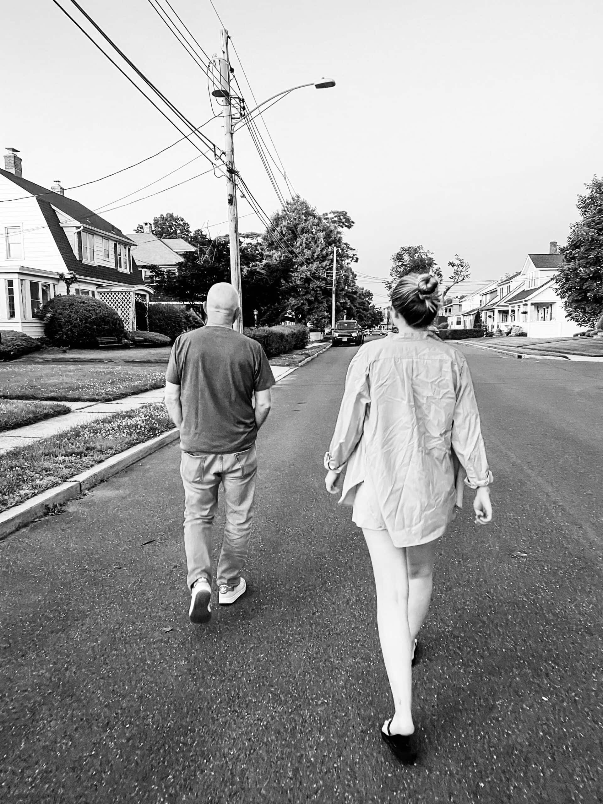 father and daughter walking in neighborhood