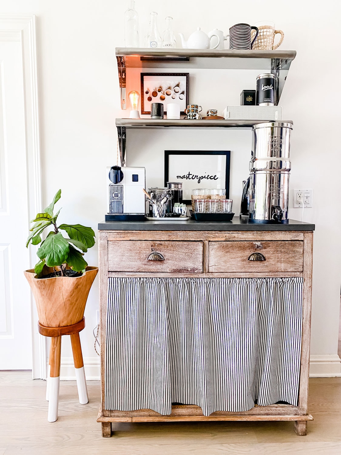 Coffee bar made from furniture with a skirted bottom and open metal shelving