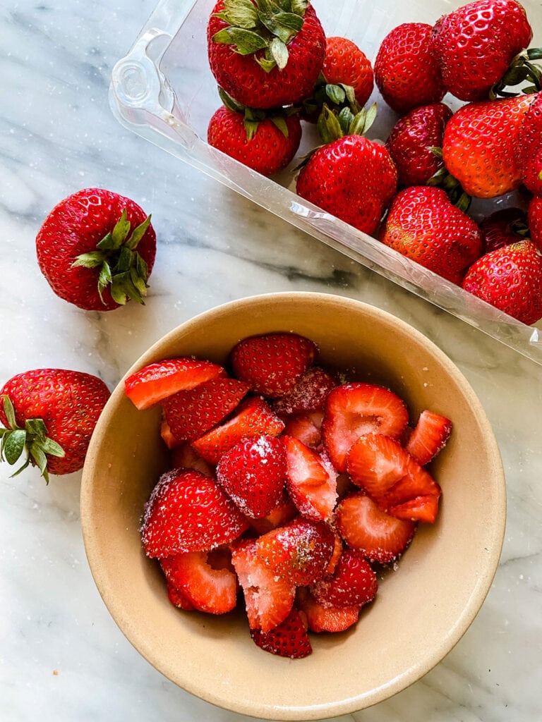 fresh cut strawberries on bowl, counter