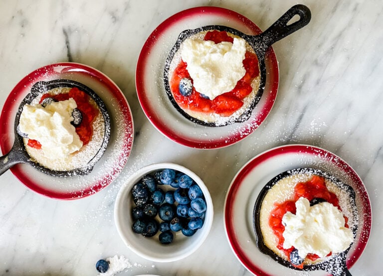 individual cast iron skillets with strawberry shortcakes with whipped topping