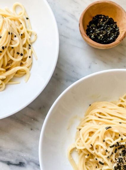 Two pasta bowls with misdo pasta sprinkled with Furikake seasoning