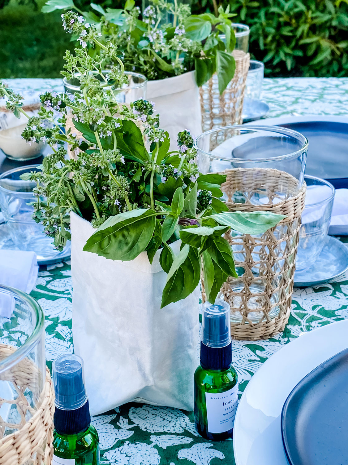 Small paper bags holding fresh herbs on the table as flowers 