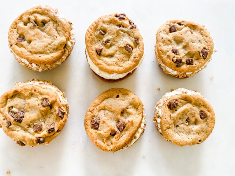 Six homemade ice cream sandwiches with chocolate chip cookies.