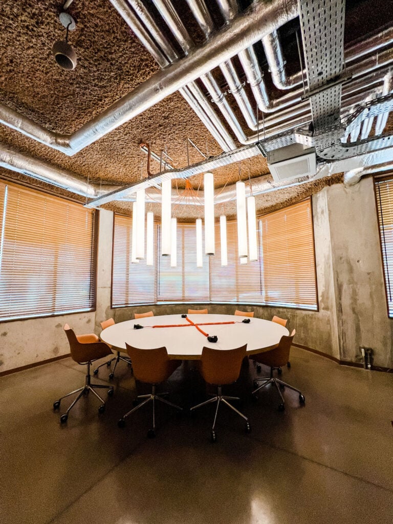 A conference room table is part of the working space inside the lobby of the Mob House hotel.