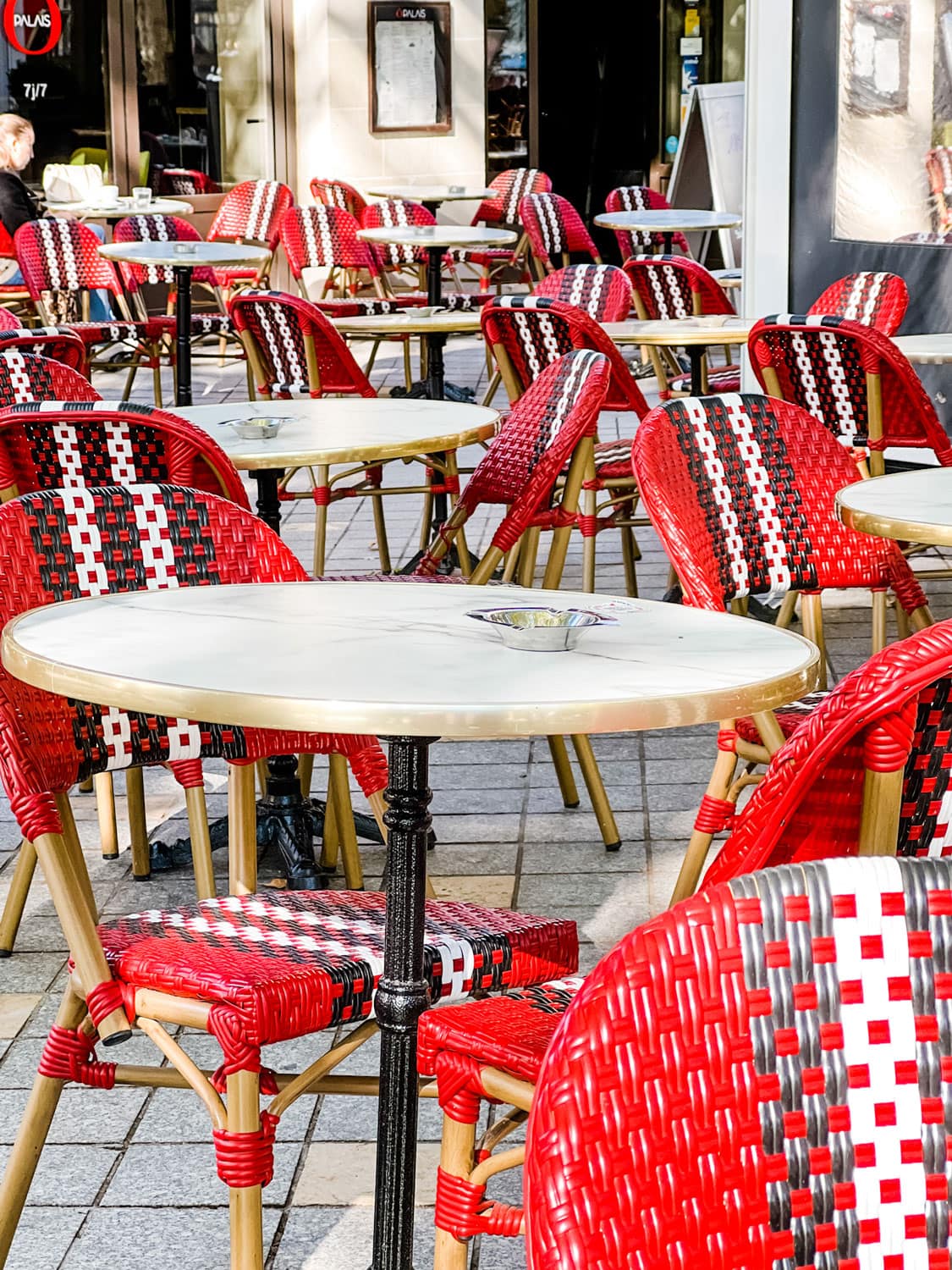 Red bistro chairs at a sidewalk cafe in Tours, France
