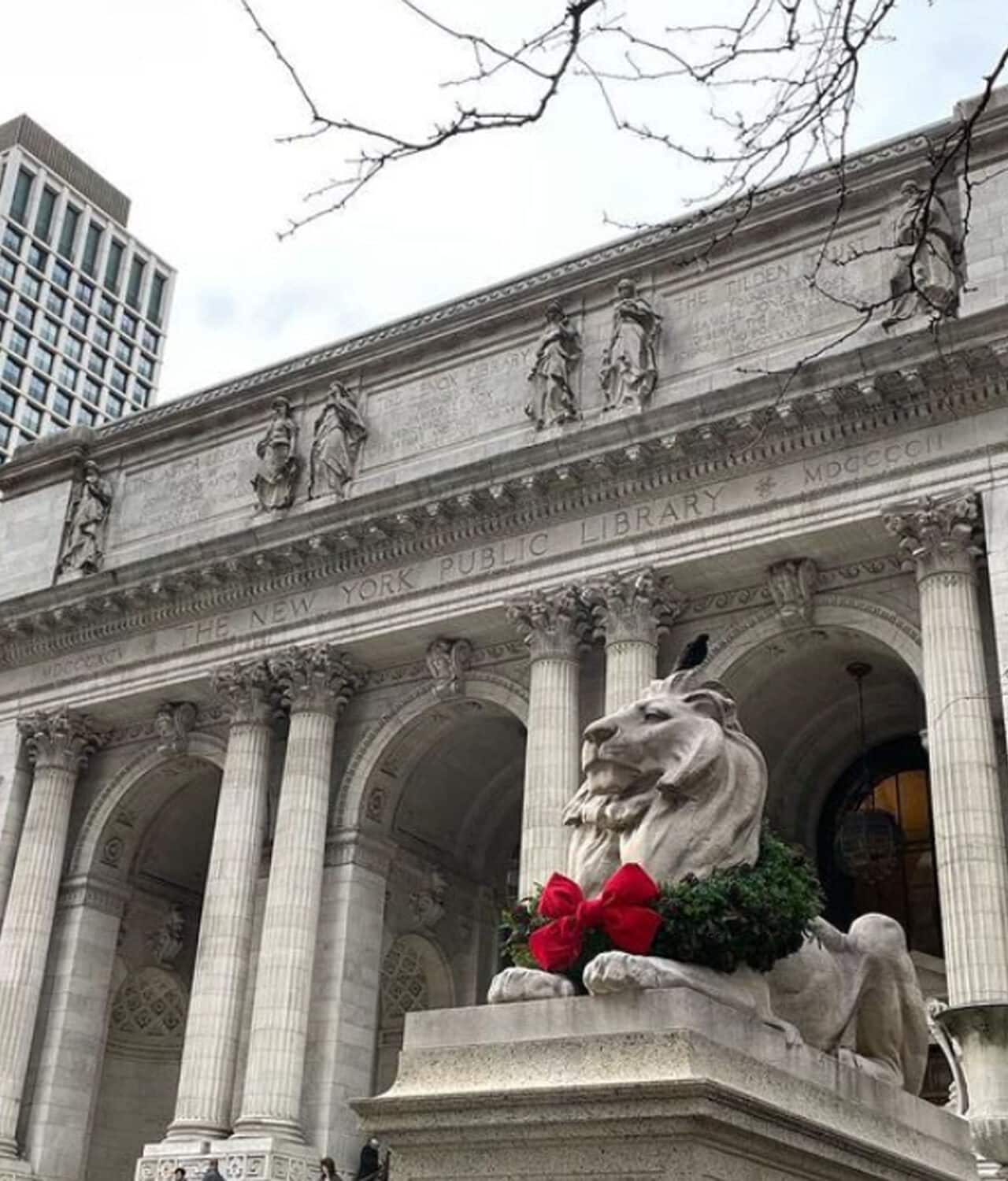 Patience and Fortitude, the marble statues at the NYPL wearing wreaths with big red bows