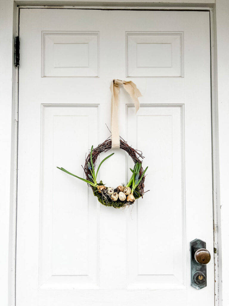 Easy Birch Twig Spring Wreath hanging on a side door to a New England beach cottage.