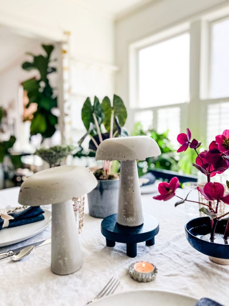 Two concrete mushrooms are the centerpiece for this beautiful tablescape.