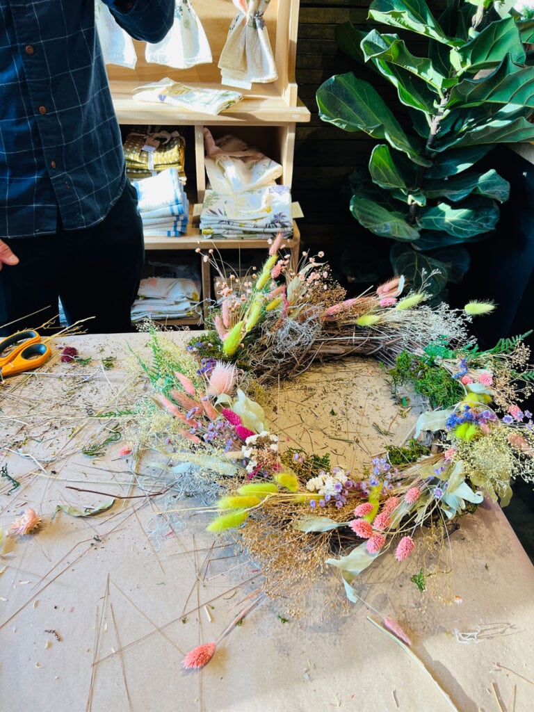 Wreath making at Terrain using dried florals using a neutral and peach theme 