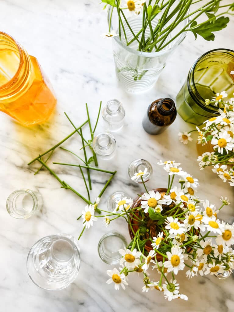 stems, flowers, tiny glass bottles, yellow tinted jar