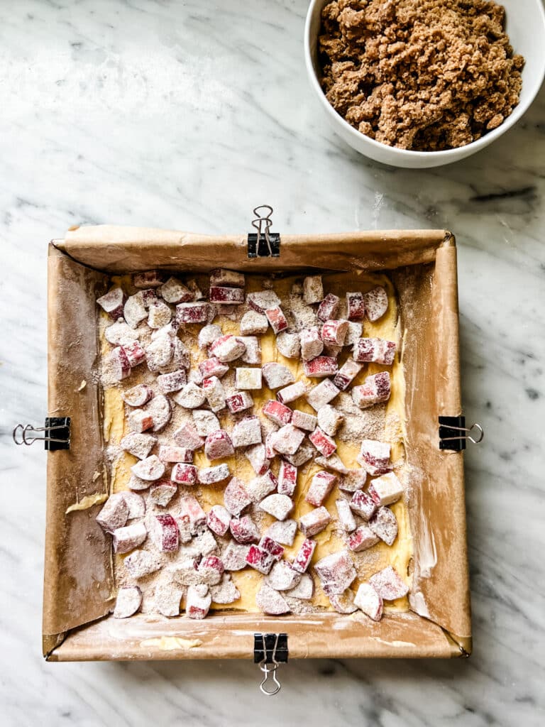 The Best Rhubarb Crumb Bar Recipe With Vanilla Cream -cake for rhubarb crumb bars and put into bottom of square cake pan lined with parchment paper. 