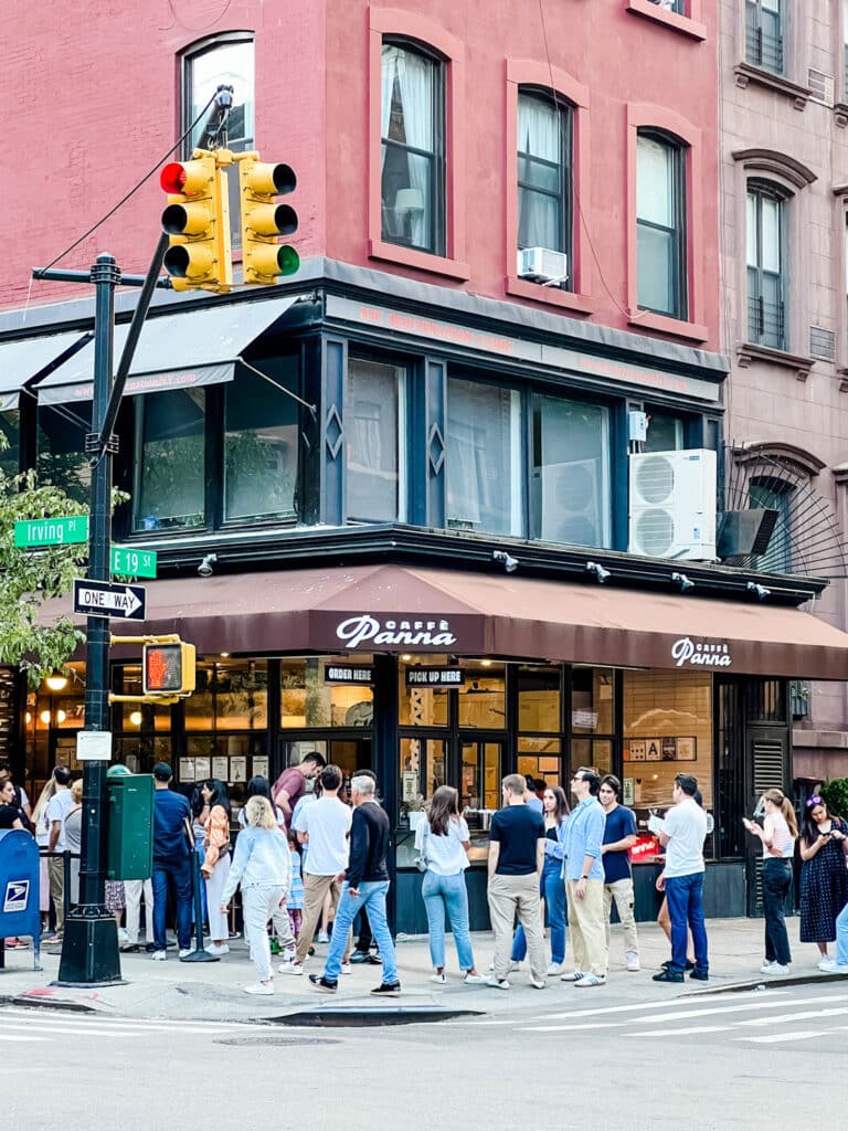 A long line of people waiting for an ice cream treat on a hot summer day in New York City.