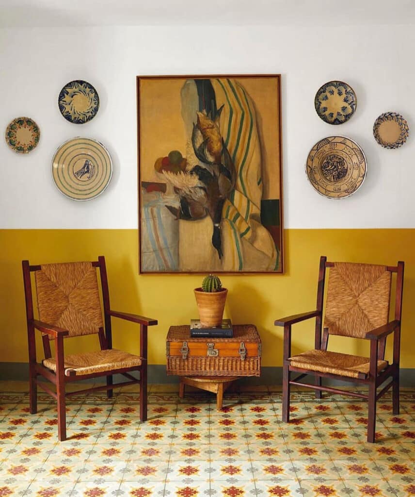 Displaying Plates on the Wall with art, chairs, tile floor 