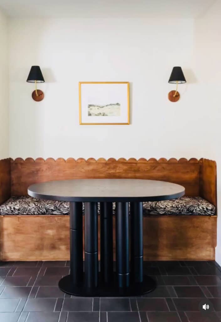 Scallop wood back in banquette, sconces, black table