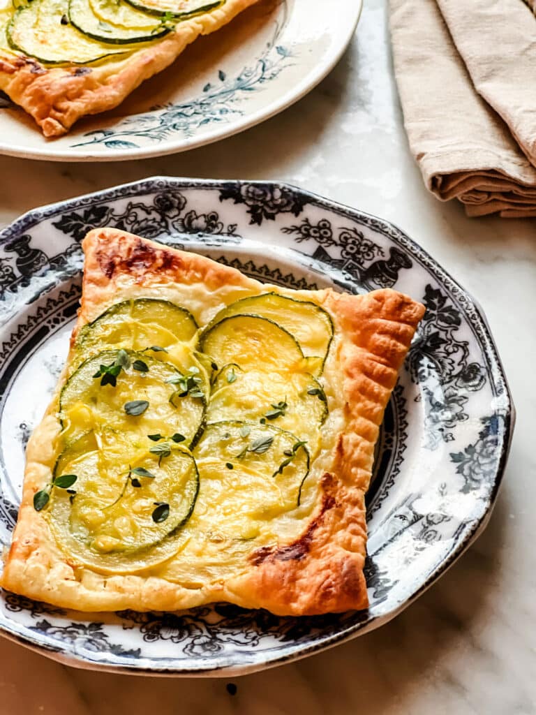 puff pastry goat cheese zucchini tarts on plates 