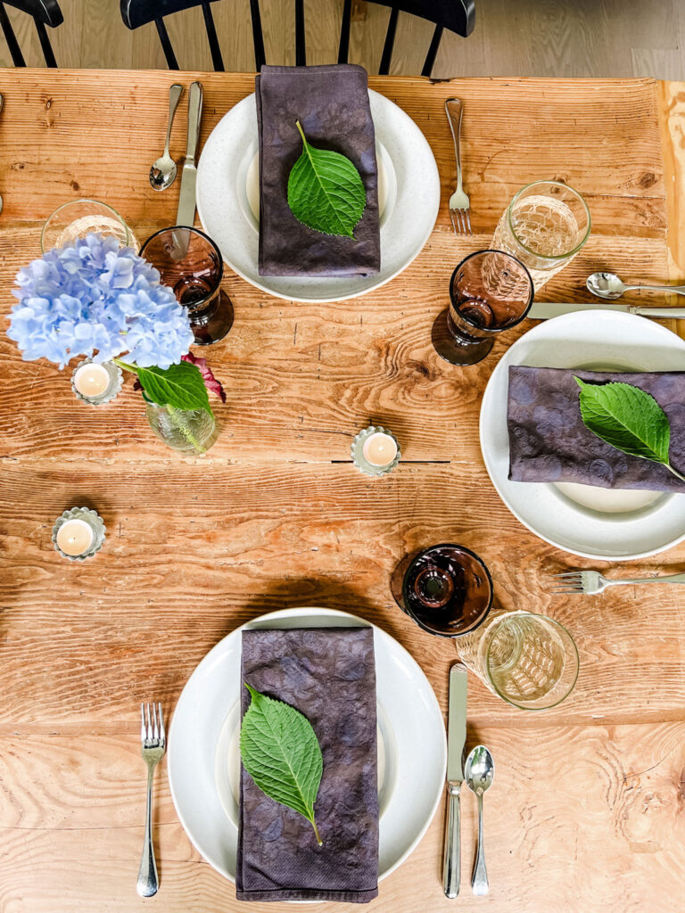 A summer Table Using Vintage Dyed Black Napkins with Hydrangea Leaves