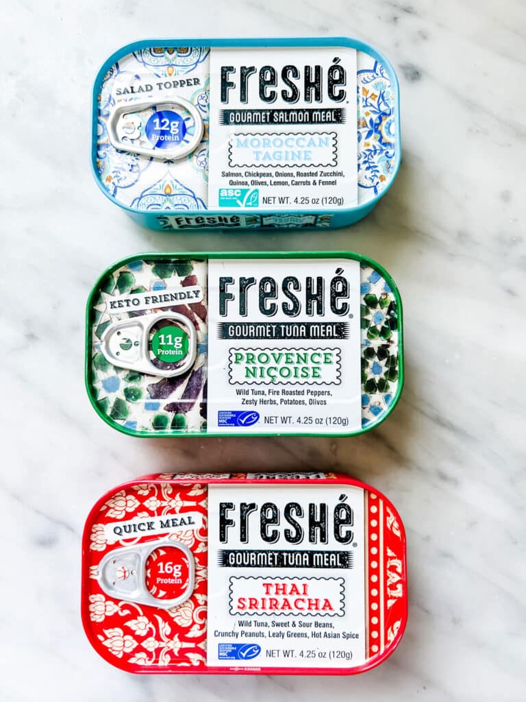The tinned fish trend has foodies of all ages talking-three tins of tinned fish in a row on a marble counter
