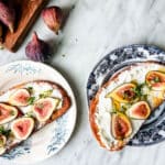 fig tartines on plates with board and figs