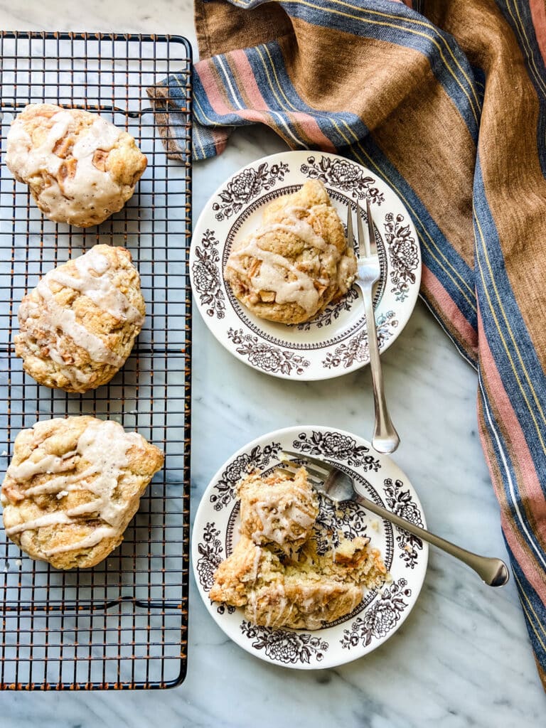 cinnamon apple scones on vintage brown floral plates with a striped linen dish towel