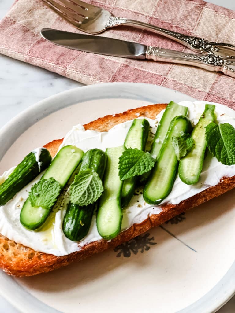 A tartine based on a dip with Labneh and Za'atar - Served on a pretty plate with a checked napkin and silver