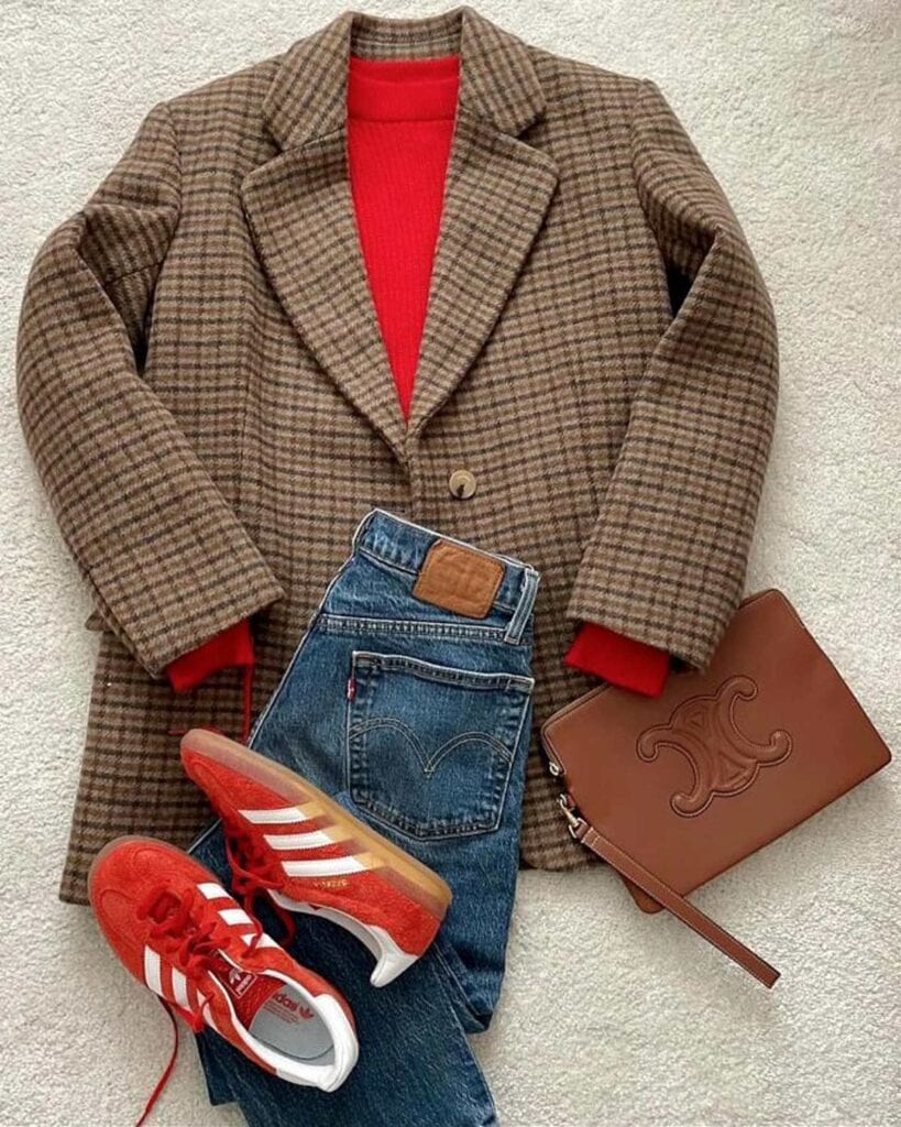 A blazer, red shirt, Levi jeans and red Adidas Gazelles.