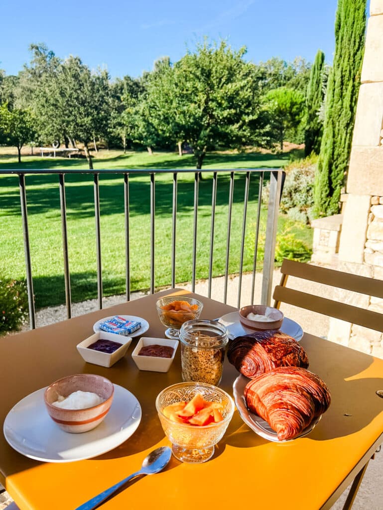Breakfast is served on the terrace overlooking the property at a French vineyard.