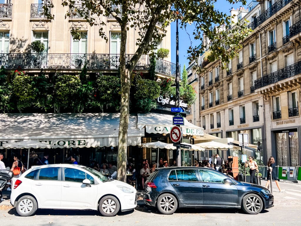 White awnings with the letters Cafe de Flore hang over people having lunch where you can get a taste of Paris with the traditional Croque Monsieur.