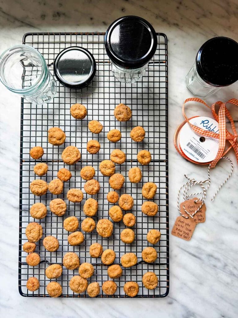 Cookies in jars with orange and white gingham ribbon and a tag.
