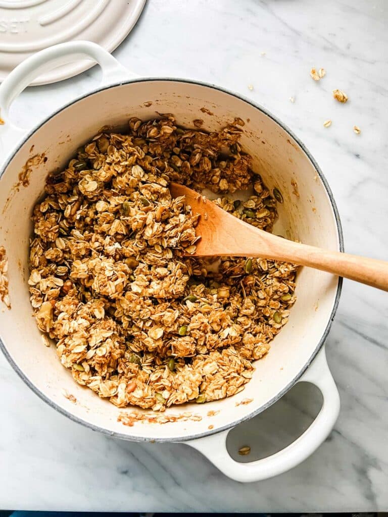 Pot of granola with wooden spoon