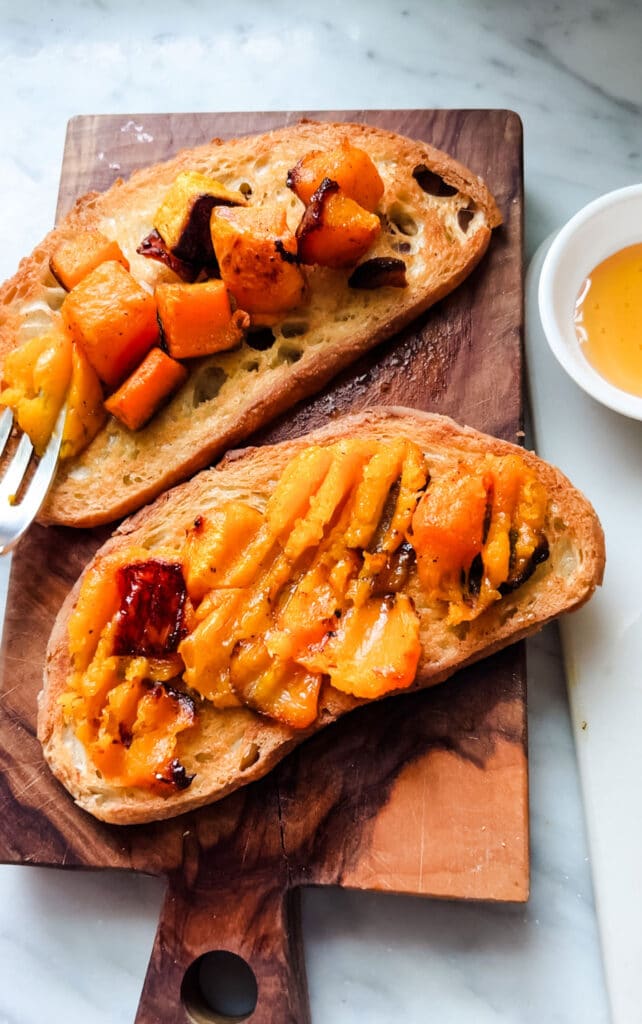 Toasted bread is topped with roasted squash.