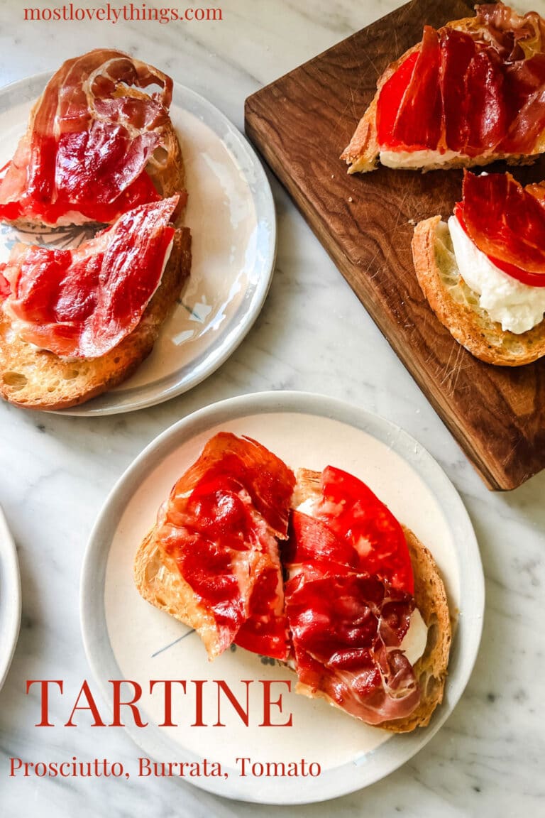 A tartine with tomato, burrata, and crispy prosciutto is served on small French vintage plates.