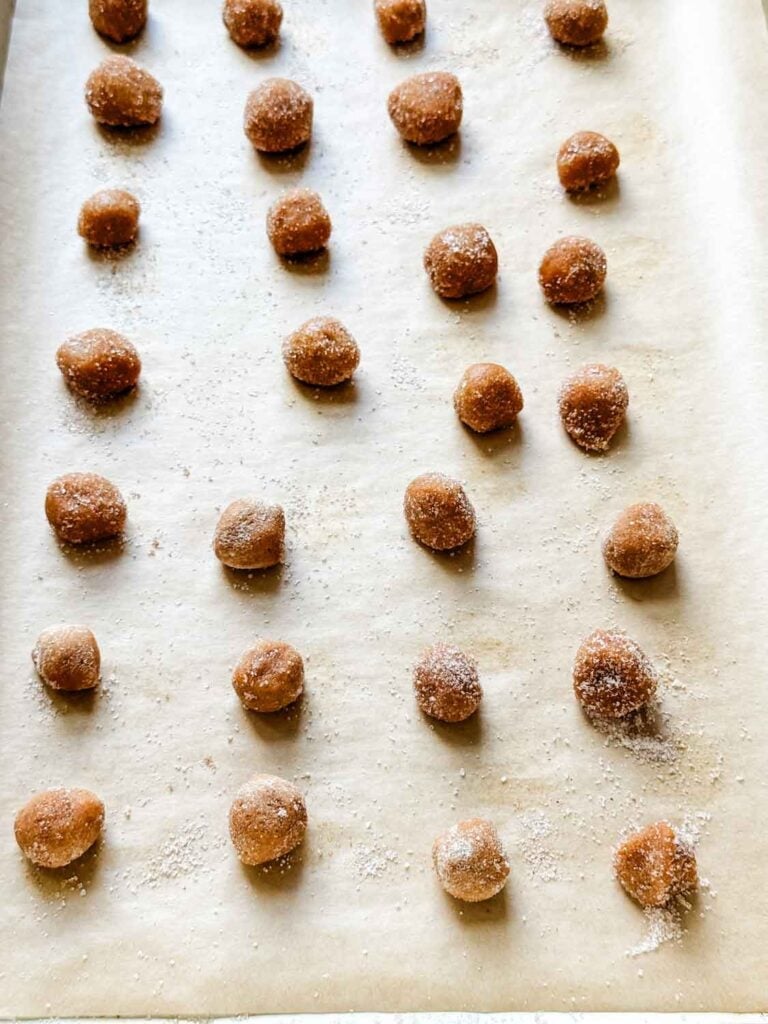 Mini snickerdoodle balls on a baking sheet.