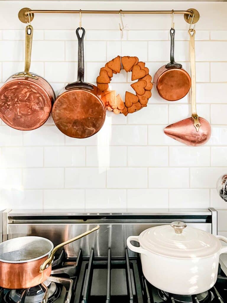 copper pots, le creuset, heart cookie wreath on stove top