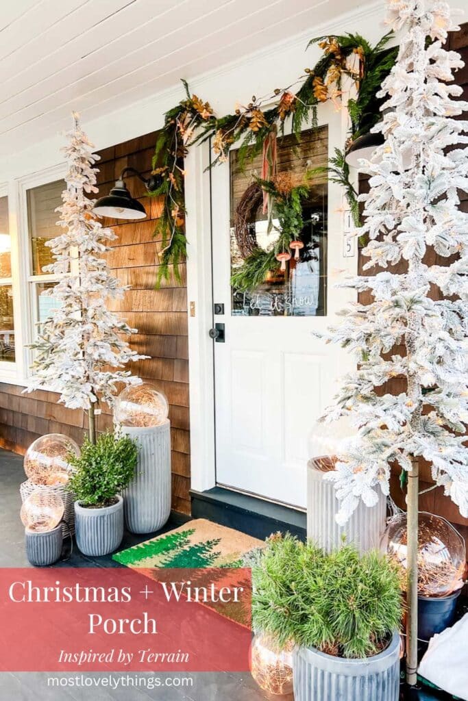 A front porch is decorated for the season with Christmas trees, garland and magical globe lights that give off a wonderful glow at night.
